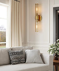 Champagne Gold Battery Operated Wall Sconces Set of 2, Rechargeable Sconce mounted beside a cozy sofa with decorative pillows.