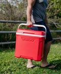 Person carrying Profile II 16 Quart Red Cooler With Fold Flat Bail Handle, Cool Riser Technology, in outdoor setting