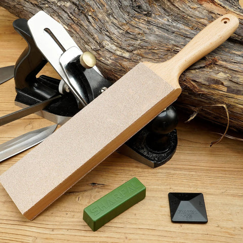 Double Sided Leather Strop Kit 13.2 By 2.4 Inches with smooth and suede surfaces next to sharpening tools on wooden surface.