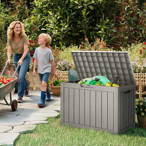 50 Gallon Outdoor Storage Box Weatherproof Resin Deck Box with Reinforced Lid used as patio bench, open with garden tools inside.