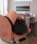 Hand holding Boss Level Precision 230 Ft Laser Distance Meter With Volume Calculation Pythagorean Mode And Stakeout Layout Angle Display.