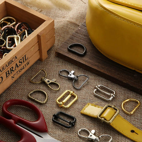 Killer Metal Bag Hardware Kit Featuring Twenty One D Rings Fourteen Swivel Snap Hooks And Twenty One Slide Buckles For Leather Stitching And Purse Making Crafts with assorted D rings and swivel snaps.