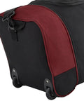 Travelers Club 32-inch expandable rolling duffel bag, black with red trim, close-up of bottom corner showing wheels.