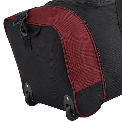 Travelers Club 32-inch expandable rolling duffel bag, black with red trim, close-up of bottom corner showing wheels.