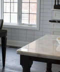 Floor Register 4x14 In Rubbed Bronze Finish With Scroll Design installed near dining area, visible under table on dark wood floor.