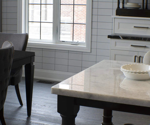 Floor Register 4x14 In Rubbed Bronze Finish With Scroll Design installed near dining area, visible under table on dark wood floor.