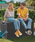 People sitting on 100-Gallon Large Resin Deck Box Waterproof Outdoor Storage For Patio Furniture Cushions Garden Tools And Pool Supplies Lockable Black All-In-One Backyard Organizer in garden