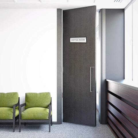 Six Pack Black Aluminum Wall Mount Name Plate Holders For Office Doors shown on a meeting room door, 8x3 inches, non glare film.
