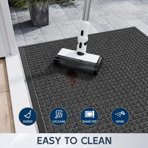 Close-up of All Weather Front Door Mat Indoor Outdoor 72 Inch By 36 Inch Non Slip Rubber Backing being cleaned on a patio.