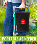 Person carrying a folded Wide 10 Inch Taller Garden Kneeler And Seat Folding Stool with Dual Use Two Tool Pouches in a garden