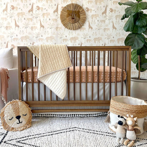 Traditional Paste The Wall Safari Nursery Wallpaper With Watercolor Lions Elephants And Giraffes Print In Neutral Jungle Tones For Baby Rooms Cozy Neutral Decor 20.87 Inch By 270 Inch Roll features in a cozy nursery with a crib and animal decor.