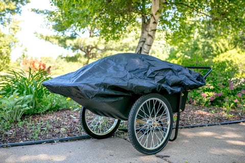 Covered Beefy Heavy Duty Utility Cart With 10 Cubic Feet Tub And 400 Pound Load Capacity With Flat Free Wheels in garden setting