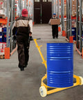 Heavy Duty 55 Gallon Oil Drum Hand Truck Hauler 1200 Lb Capacity Steel Barrel Roller Cart moving a blue drum in a warehouse aisle.