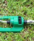 Green garden tool connected to hose with Heavy Duty 3/4 Inch Garden Hose Repair Kit With Stainless Steel Male And Female Ends