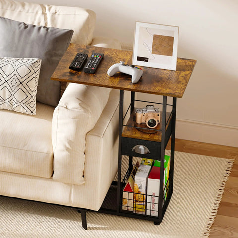 C-Shaped Side Table With Wheels And Large Wood Top next to sofa, holds remotes, game controller, sturdy metal frame.