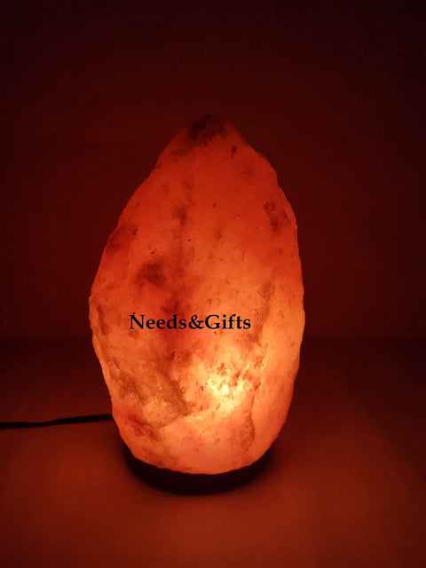 Dimmed glow from Dimmable Pink Himalayan Salt Lamp With Handcrafted Wooden Base, showcasing natural crystal texture and warm light.