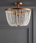 Antique Gold 3 Light Flush Mount Chandelier With Quartz Bead Accents In Stone And Metal For Dining Room Or Bedroom Modern Transitional Style LED Bulbs Included Lit Upgrade, showcasing quartz beads over an antique gold frame against a grey wall.