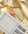 Keep Your Daily Bling Neatly Stashed In This Slick Gray Velvet Jewelry Organizer Tray With Elastic Grid For Rings Earrings Necklaces Watches Glasses Totally Solid For Home Or Store Display, showcasing gold chains beside a soft beige fabric.