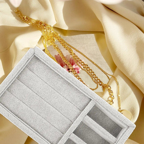 Keep Your Daily Bling Neatly Stashed In This Slick Gray Velvet Jewelry Organizer Tray With Elastic Grid For Rings Earrings Necklaces Watches Glasses Totally Solid For Home Or Store Display, showcasing gold chains beside a soft beige fabric.