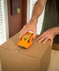Person using Tough As Nails Clear Packing Tape For Moving And Storage 2.83 Inch By 30 Yard Two Rolls Strong Tear Resistant Adhesive