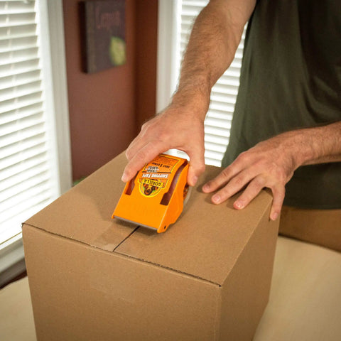 Person using Tough As Nails Clear Packing Tape For Moving And Storage 2.83 Inch By 30 Yard Two Rolls Strong Tear Resistant Adhesive