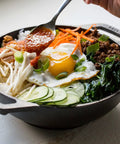 Mini Cast Iron Wok For Stir Fry Lovers with food, 9 inch naturally seasoned, features egg, vegetables, sauce being added