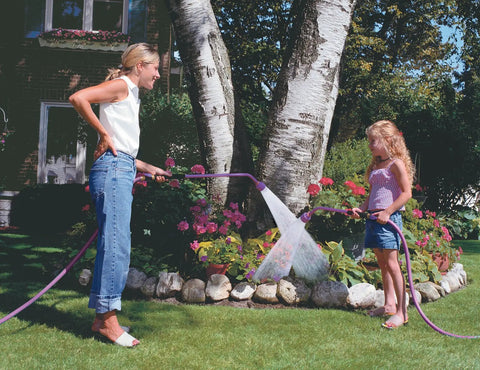 Woman and child using Sunrise Soft Rain Watering Spray Wand 30 Inch With Shut Off Valve Berry Color in garden