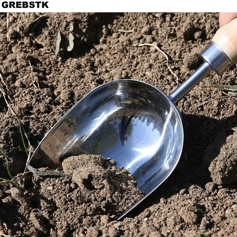 Beefy Capacity Garden Scoop Stainless Steel Soil Shovel with beech handle digging in soil, ideal for home garden use.