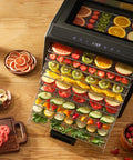Keep It Fresh With This Top Shelf Electric Food Dehydrator Boasting Ten Rustproof Stainless Steel Trays with fruits on display.
