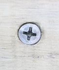 Close-up of Number Twelve By One Inch Stainless Steel Wood Screws Flat Head Phillips Drive embedded in wood.