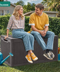 Two people sitting on 100 Gallon Large Deck Box Outdoor Resin Storage For Patio Furniture Cushions And Garden Tools Weatherproof Lockable Lid With Gas Strut Side Handles And Sturdy Bench Seating Up To 485 Pounds