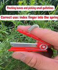 Hand holding All Purpose Gardener Thumb Knife And Pruning Shears With No Fuss Design for leaf trimming, finger spring shown.
