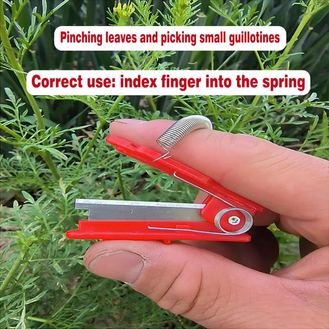 Hand holding All Purpose Gardener Thumb Knife And Pruning Shears With No Fuss Design for leaf trimming, finger spring shown.