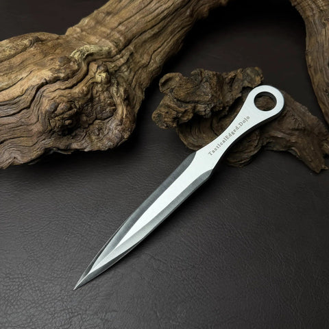 Kunai Inspired Throwing Tool With Full Tang Stainless Steel Build, 8.66 Inch Blade resting on wood