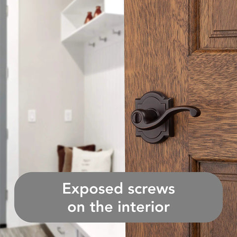 Entry Door Lever Handle With Keyed Lock And SmartKey Re-key Technology on wooden door, exposed screws shown, in Venetian Bronze.
