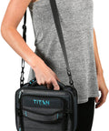 Heavy Duty Expandable Lunch Pack With Dual Food Containers And Pro Grade Ice Walls For Hella Superior Cooling And Zero Leak Stress In Smooth Black And Blue Travel Bag, held by woman wearing gray top.
