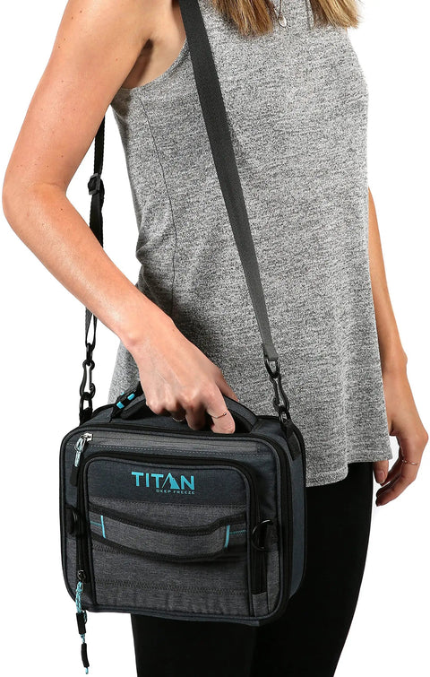 Heavy Duty Expandable Lunch Pack With Dual Food Containers And Pro Grade Ice Walls For Hella Superior Cooling And Zero Leak Stress In Smooth Black And Blue Travel Bag, held by woman wearing gray top.