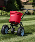 Heavy Duty 50 Lb Broadcast Fertilizer Spreader For Lawns with large 13 inch pneumatic stud tires on grass