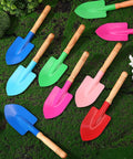 30 Piece Mini Garden Shovel Set Colorful Metal Tools With Wooden Handles for planting and beach play on grassy surface.