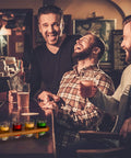 Kick Back Wooden Shooting Board Set With Eighteen Shot Glasses For Chill Game Nights at a bar with smiling friends.