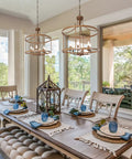 Dining room with two Rustic Bronze Farmhouse Six Light Drum Chandeliers over a wooden table set for a meal, cozy vibe.