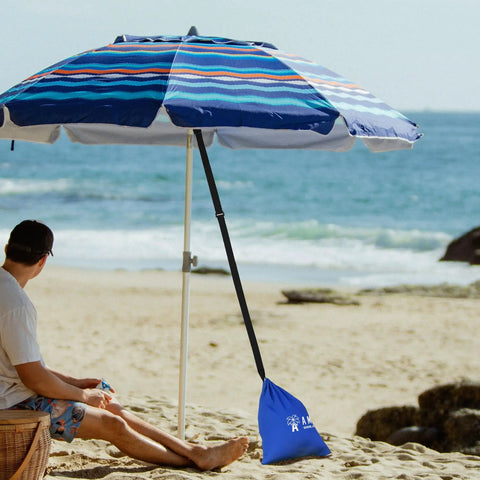 Beach Umbrella Sand Anchor Bag Windproof Weight For Heavy Wind securing a blue beach umbrella on sandy beach