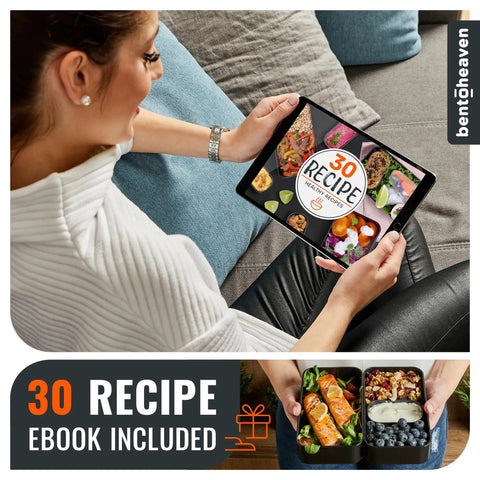 Woman reading tablet recipe ebook with Premium Bento Box With 2 Stackable Compartments, 40 Oz Capacity alongside, meals shown.