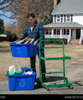 Man using Tough As Nails Heavy Duty Recycle Bin Cart with Aluminum Frame, loading cardboard into blue recycling bins.