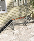 Wooden Dog Agility Ramp With Safety Bar And Non Slip Surface For Backyard Park Training Obstacle Course Dual Color Visibility For Easy Spotting Gentle 35 Degree Slope Durable Gray setup against brick wall