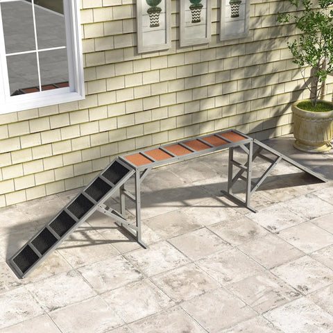 Wooden Dog Agility Ramp With Safety Bar And Non Slip Surface For Backyard Park Training Obstacle Course Dual Color Visibility For Easy Spotting Gentle 35 Degree Slope Durable Gray setup against brick wall
