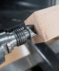 MT2 woodturning lathe live and drive center set installed on a wooden block between centers