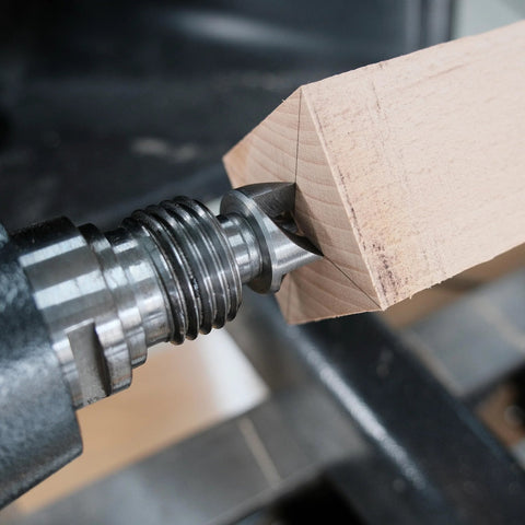 MT2 woodturning lathe live and drive center set installed on a wooden block between centers