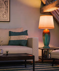 Elaine Table Lamp With Antique Mercury Glass And Brushed Steel Finish, 29.5 Inch Tall White Drum Shade in cozy living room setting