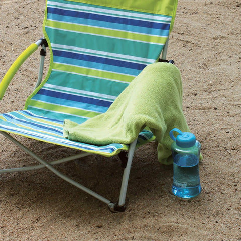 Utopia Breeze Lightweight Beach Chair With Cup Holder And Carry Bag For Easy Outdoor Relaxation on sand with towel and bottle